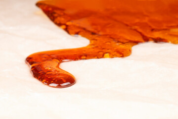 amber cannabis resin closeup, thc wax rosin.