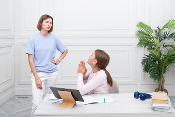 Mother angry with her daughter when she studies online at home	 - obrazy, fototapety, plakaty