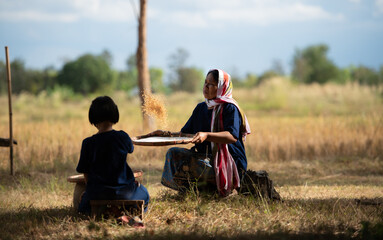 Rural life of Thai farmers More than 70% have to live on farming. Sifting rice with baskets that farmers