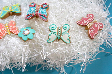 Gingerbread cookies butterflies and flowers. Easter Conception. Colored Background. Wide Banner.