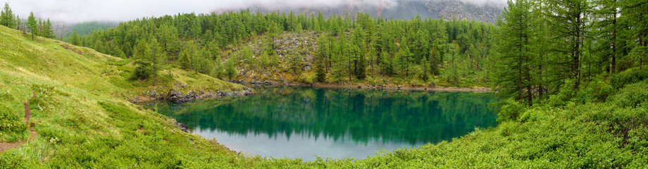 Fototapeta na wymiar Kuektanar lake in the forest , in Altai