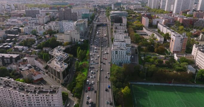 Cars are moving in heavy traffic on the bridge located in the capital of France. Rush hour traffic in the business district of Paris. Drone view of the urban set of cars