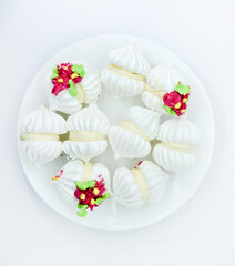Delicious bizet marshmallows on a white plate. A sweet snack. Marshmallows for tea.