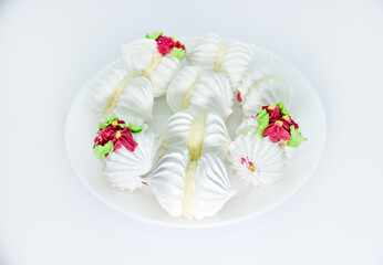 Delicious bizet marshmallows on a white plate. A sweet snack. Marshmallows for tea.