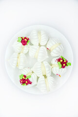 Fototapeta na wymiar Delicious bizet marshmallows on a white plate. A sweet snack. Marshmallows for tea.