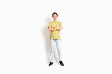 Naklejka premium Single skinny young male. The full body of an Asian or Indonesian person. Isolated photo studio with white background.