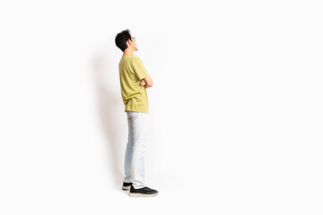 Single skinny young male. The full body of an Asian or Indonesian person. Isolated photo studio with white background.