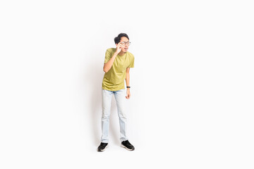 Single skinny young male. The full body of an Asian or Indonesian person. Isolated photo studio with white background.