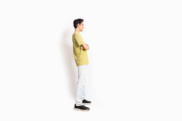 Naklejka premium Single skinny young male. The full body of an Asian or Indonesian person. Isolated photo studio with white background.