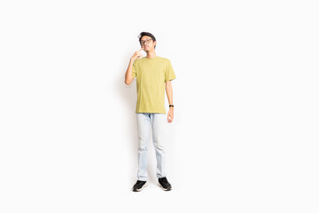 Single skinny young male. The full body of an Asian or Indonesian person. Isolated photo studio with white background.