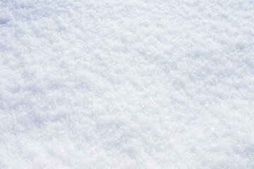 snow background. Snowflakes sparkle on the white surface of the snow