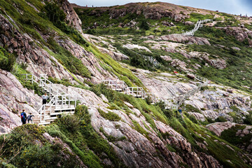 A family of tourists hiking the Battery Trail along Signal Hill in St. John's Harbour Newfoundland Canada.