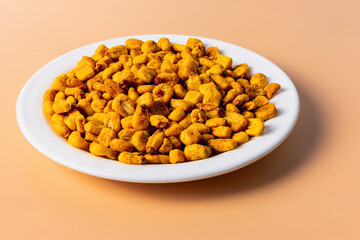 Roasted corn kernels on an orange background