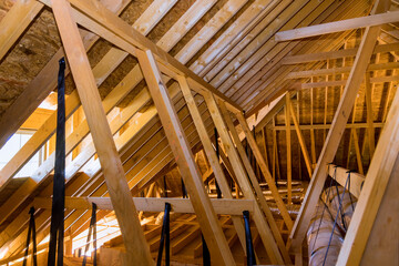 Obraz premium Ventilation pipes in silver insulation material on ceiling inside newly built home under construction
