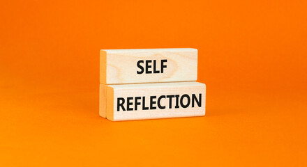 Self reflection symbol. Concept word Self reflection typed on wooden blocks. Beautiful orange table orange background. Business psychological and self reflection concept. Copy space.