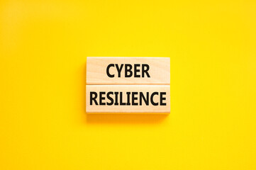 Cyber resilience symbol. Concept word Cyber resilience typed on wooden blocks. Beautiful yellow table yellow background. Business and cyber resilience concept. Copy space.