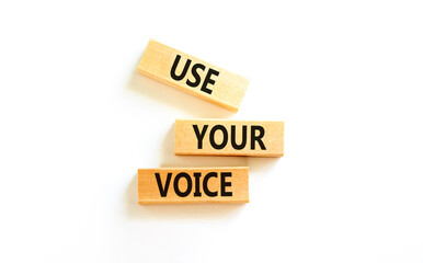 Use your voice symbol. Concept words Use your voice on wooden blocks on a beautiful white table white background. Business and use your voice concept. Copy space.