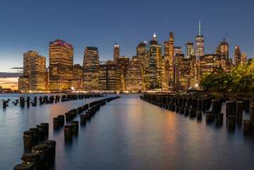 NYC Cityscape in Sunset Light. Old Pier in Foreground. Lower Man