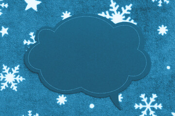 Blank talk bubble chalk sign on snowflake fabric