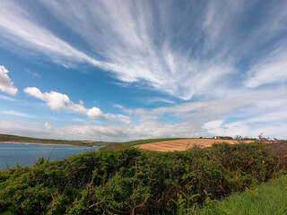 The sky with clouds over the fields. Beautiful landscape. Nature of the South of Ireland.