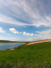 The sky with cirrus clouds over the fields. Beautiful landscape. Nature of the South of Ireland. Countryside on a fine day.