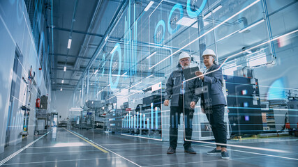 Factory Digitalization: Two Industrial Engineers Use Tablet Computer, Visualize the Wall of Big Data Statistics, Optimization of High-Tech Electronics Facility. Industry 4.0 Machinery Production - obrazy, fototapety, plakaty