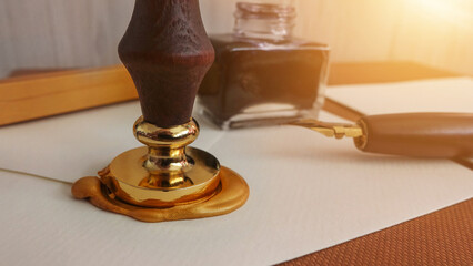 Authentic official luxury letter with a gold sealing wax stamp. Writing a letter with an old...