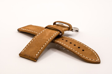 detailed close up of a vintage camel oak watch strap with metal pin and buckle 