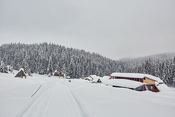 Wooden barn in the mountains at wintertime