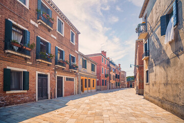 Fototapeta na wymiar Italian street with colorful buildings in Venice