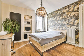 a bedroom with wood flooring and wallpaper on the walls behind it is a bed that has a wooden...