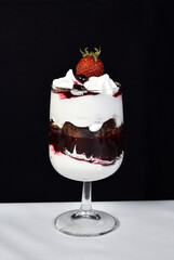 dessert in bowl with fruits on black background