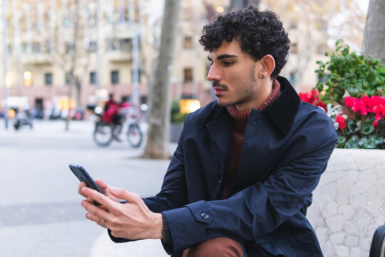 Guy using cellphone on street