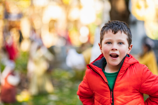 Amazed boy in autumn park