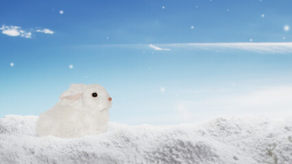 Naklejka premium Cute rabbit in the snow. Winter postcard. Winter banner. Snow, rabbits, winter, sky.
