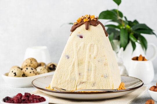 Traditional cottage cheese Easter paskha and eggs on white table. Russian paskha. Easter dessert. Easter table. Still life. Cottage cheese dessert.