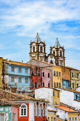 Fototapeta na wymiar Historic church tower between the roofs and facades of houses in the famous Pelourinho neighborhood in Salvador Bahia