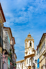 Fototapeta na wymiar Historic church tower between the colorful houses in the famous Pelourinho neighborhood in Salvador Bahia