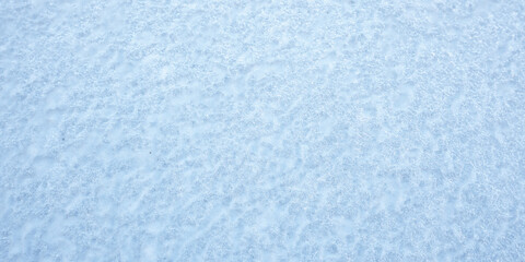 Blue and white clean snow background outdoor in winter time. Textured backdrop of fresh snow.
