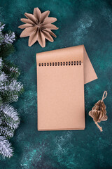Christmas composition with empty craft notebook