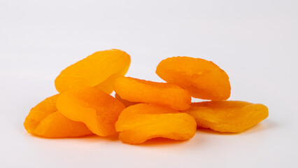 heap of dried apricots  on white background