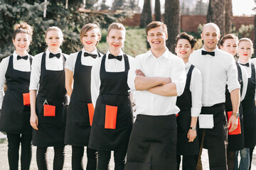 Manager and a group of young hotel staff standing together