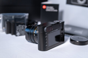 Fototapeta na wymiar Beautiful vintage looking modern digital Leica Q camera in front of the box and accessories