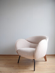 Moderno mueble de lectura minimalista beige al Interior de una sala con  piso laminado y pared gris con  iluminado con luz natural