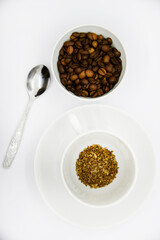 Toasted coffee beans in a porcelain cup. Coffee mixture. Delicious coffee beans and freeze-dried.