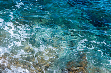 Clear blue waters of Aegean Sea on Tinos island, Cyclades, Greece