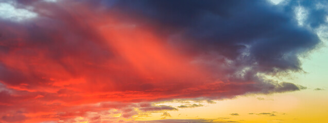 Obraz premium Colorful sunset in orange yellow and blue over orchard meadows in Siebenbrunn near Augsburg