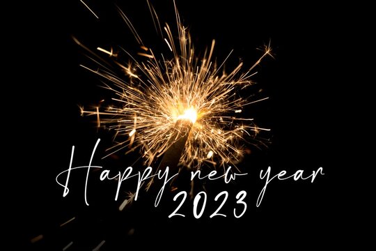Happy new year 2023 orange sparkler new years eve countdown. Luxury entertainment celebration turn of the year party time. Premium nightlife visual with glowing light sparks on dark background