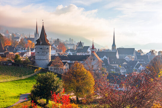 A breathtaking panoramic view of the buildings and fortifications of the old town of Zug in autumn, the Guggi Vantage Point in Zug