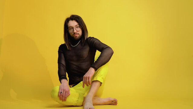 Portrait of a metrosexual man on a yellow background